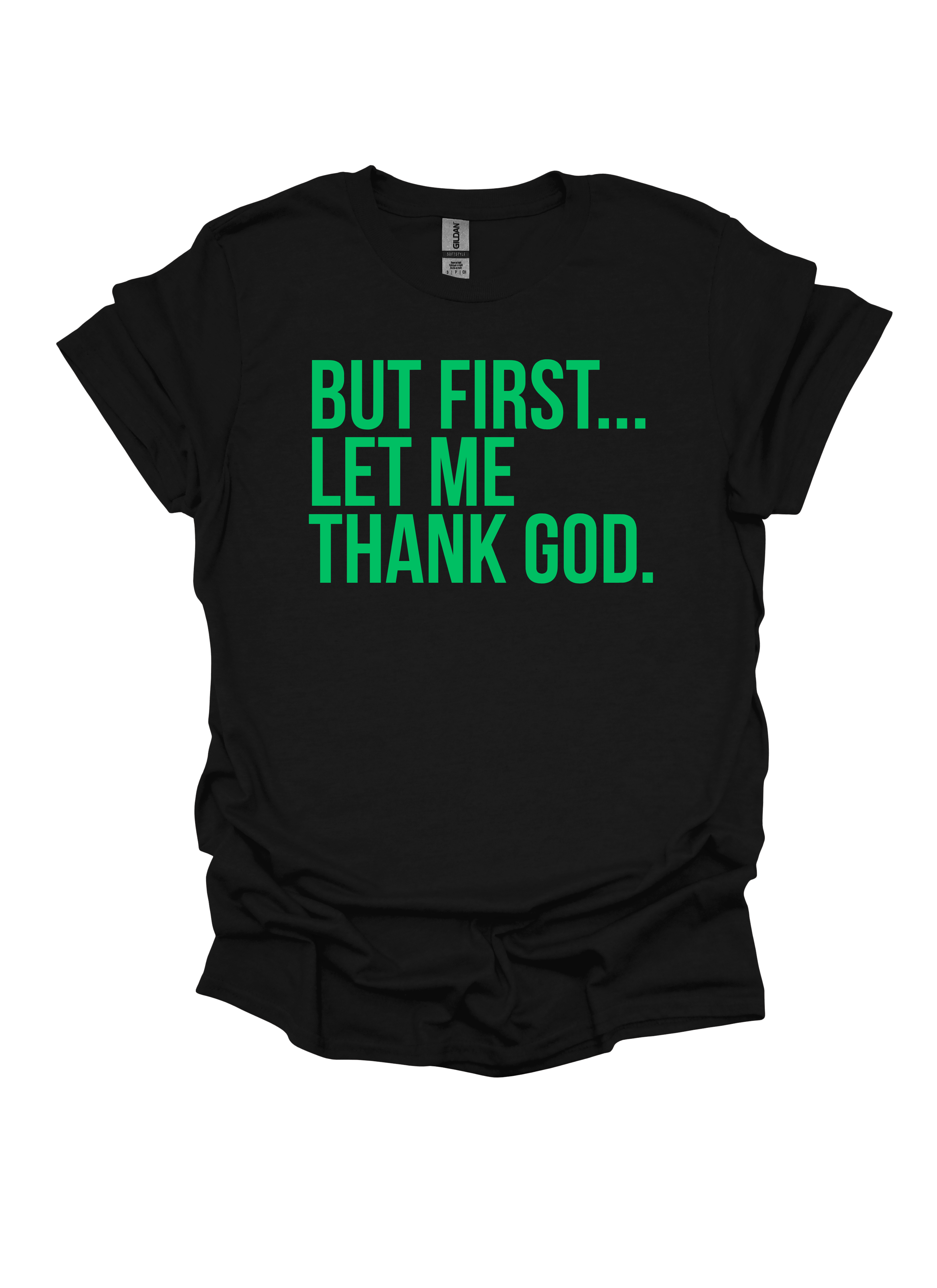 Black t-shirt with green text 'BUT FIRST... LET ME THANK GOD' on a white background